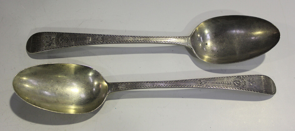 A pair of George III silver Old English pattern table spoons with bright cut engraved decoration, Lo