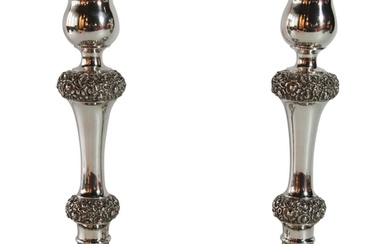 A pair of German Silver rounded candlesticks with stylized f...