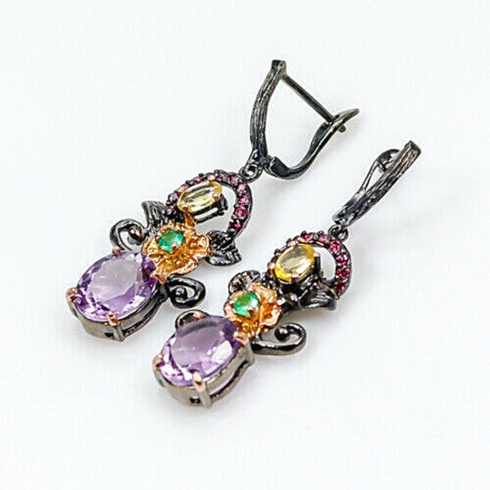 A pair of ear pendants each set with numerous oval and circular-cut amethysts, citrines, onyx and garnets, mounted in rhodium and gold plated silver.