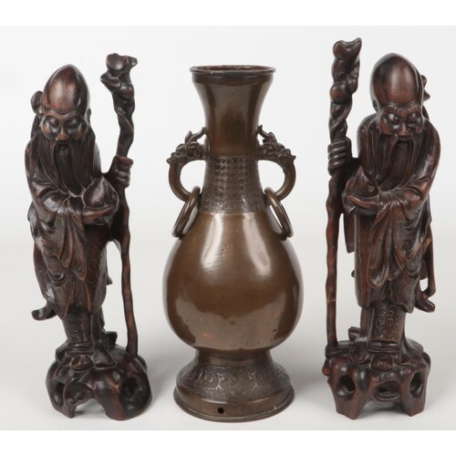 A pair of early 20th century Chinese carved hardwood figures...