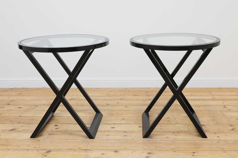 A pair of modern black-painted wood and glass side tables