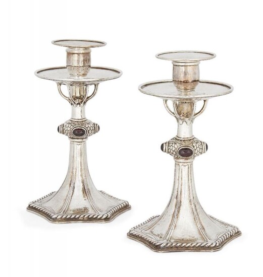 A pair of silver plated candlesticks in...