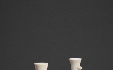 A pair of white-glazed 'dragon' bottle vases, Qing dynasty, 18th...