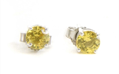 A pair of white gold single stone yellow sapphire stud earrings