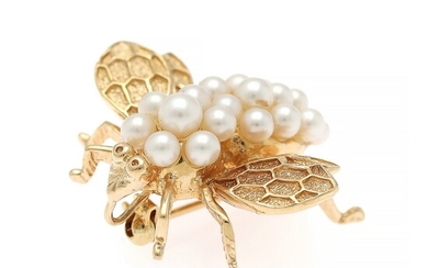 NOT SOLD. A pearl brooch set with numerous cultural pearls, mounted in 14k gold. Measures...