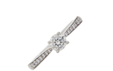 A platinum brilliant-cut diamond single-stone ring, with sim...