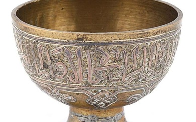A single early 20th century zarf (coffee holder) made of brass and inlaid with silver.