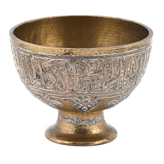 A single early 20th century zarf (coffee holder) made of brass and inlaid with silver.