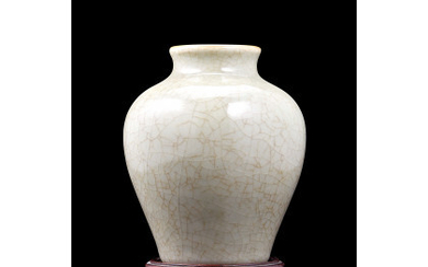 A small celadon vase, on wood base China, late Qing dynasty (h. 13.6 cm.)
