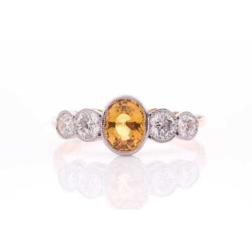 A yellow metal, diamond, and yellow sapphire ring, set with ...