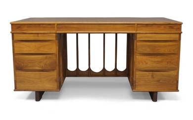 Alan Peters (1933-2009), a Devon walnut and rosewood desk, 1989, two pedestals of four graduated drawers joined by inverted arch tracery, 74cm high, 153cm wide, 76cm deep CITES Article 10 Certificate No: 6163144/01 Provenance: Commissioned by TSB...
