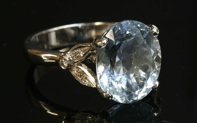 An 18ct white gold single stone aquamarine ring with diamond set shoulders