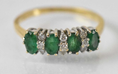 An 18ct yellow gold emerald and diamond ring set with...