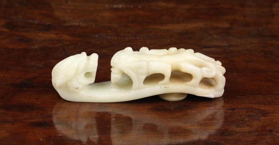 An Antique Chinese White Jade Belt Hook with zoomorphic carving, 2½'' (6.5 cm) in length.