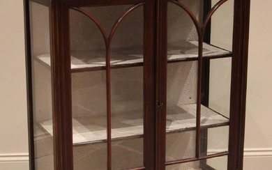 An Edwardian mahogany display cabinet, the crossbanded friez...