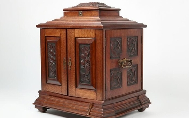 An English carved walnut tobacco / table cabinet