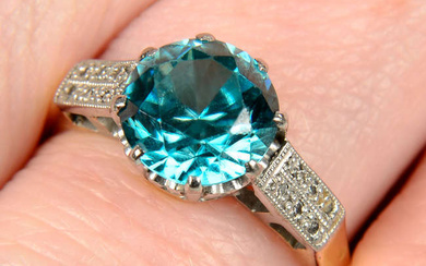 An early to mid 20th century platinum and 18ct gold blue zircon ring, with single-cut diamond bar shoulders.