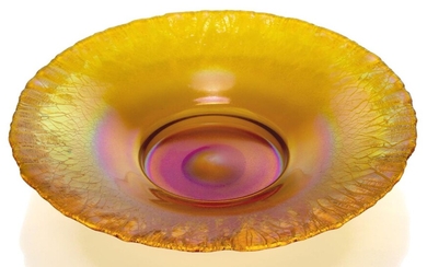 Attributed to WMF, a 'Myra' iridescent glass dish, c.1930, ground out pontil, Decorated with orange, pink and green iridescence dispersing towards the rim, 31cms diameter