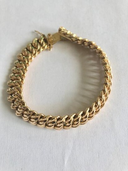 Bracelet in yellow gold 750 thousandths American stitch, ratchet clasp and safety chain 20.2 g, length: 18 cm.