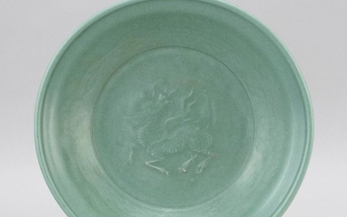 CHINESE CELADON STONEWARE CHARGER With an unusual relief qilin design surrounded by a floral border. Diameter 12".