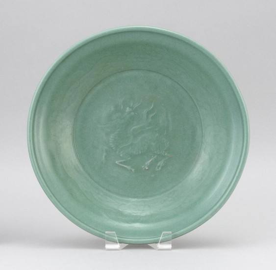 CHINESE CELADON STONEWARE CHARGER With an unusual relief qilin design surrounded by a floral border. Diameter 12".