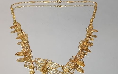 Filigree gold necklace decorated with butterflies alternating with...