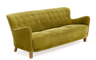 Fritz Hansen, style of: Upholstered sofa covered with green velour, fitted with buttons, stained beech legs. 1940s. L. 186 cm.