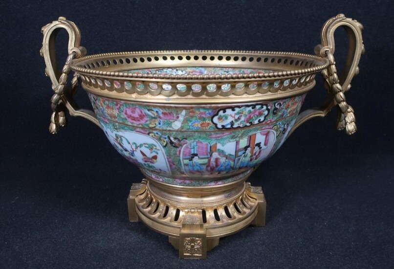 Important Canton porcelain bowl with polychrome decoration of palace scenes and flowers, insects and butterflies in reserve on a polychrome and gilded background of flowers and butterflies, gilded and openwork bronze mounting in the Louis XVI style...