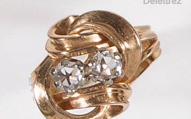 Knot" ring in yellow gold, set with two rose-cut diamonds....