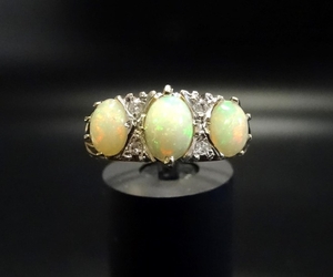 OPAL AND DIAMOND RING the three oval cabochon opals separate...