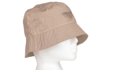 Prada, a Tesutto bucket hat, crafted from beige nylon, featu...