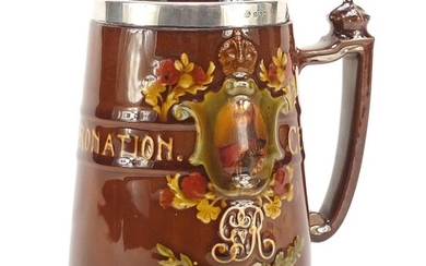Royal Doulton tankard with a silver collar commemorating Geo...