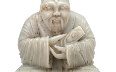 WHITE JADE CARVING OF A SEATED IMMORTAL Ming...