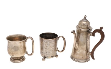 TWO EARLY 20TH CENTURY SILVER MUGS. one with engraved decora...