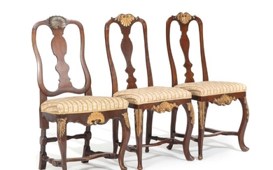 Three 18th century stained and gilded wood Rococo chairs, carved with shells and foliage. (3)