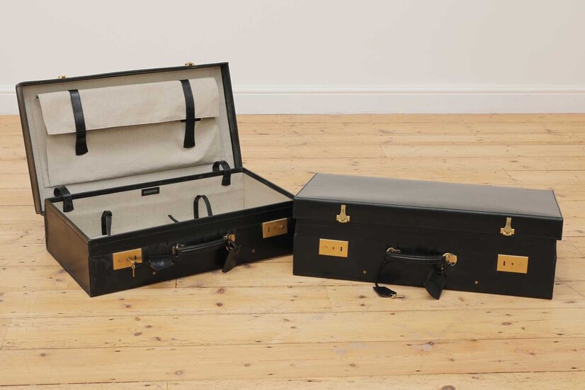 Two graduated black leather suitcases by Tanner Krolle