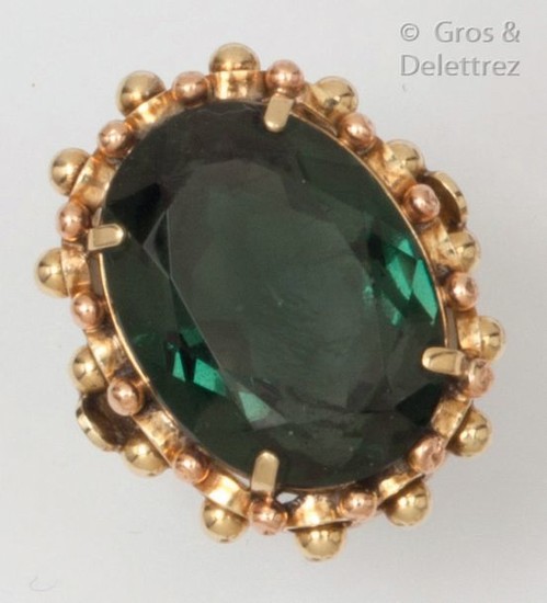 Yellow gold ring, set with a green stone...