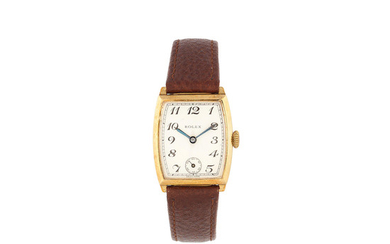 A 9K gold manual wind tonneau form wristwatch