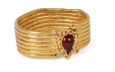 An ancient gold ring with pear-shaped red...
