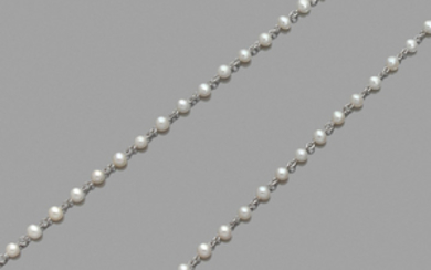 CULTURED PEARL NECKLACE A cultured pearl and platinum long necklace....