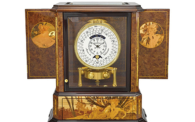 Jaeger-LeCoultre. An exceptional and very rare wood, gilt brass and glass limited edition art nouveau style atmos clock with 1000 year calendar and moon phases, wood marquetry panels by Philippe Monti and Jérôme Boutteçon after Alphonse Mucha, SIGNED...