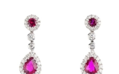 A pair of ruby and diamond earrings. Each designed as a