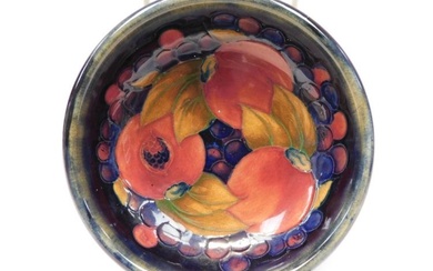 A 1920's William Moorcroft blue ground bowl in the pomegranate...