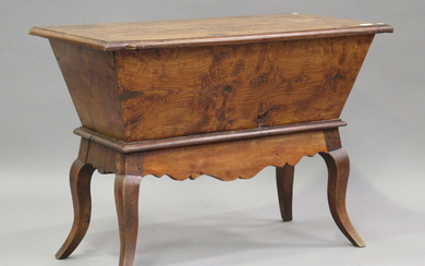 A 19th century Continental elm and fruitwood dough bin, the removable lid above shaped legs, height