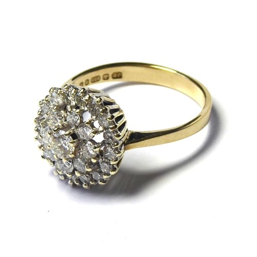 A 9CT GOLD AND DIAMOND CLUSTER RING The arrangement of round...
