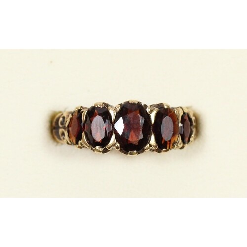 A 9ct five stone garnet ring, carved claw set, N, 3.4gm