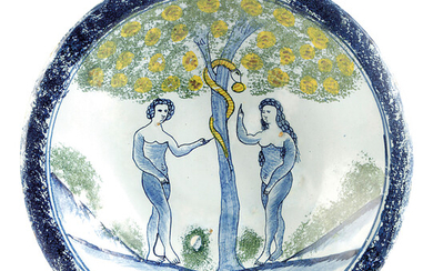 A BRISTOL DELFTWARE POTTERY ADAM AND EVE CHARGER