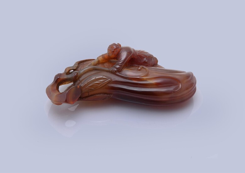 A Chinese carved agate 'Finger citrus and boy' paper weight