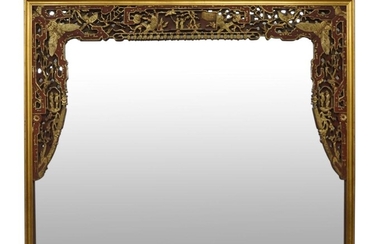 A Chinese gilt lacquer wood panel mounted as wall mirror, early 20th century, pierced and carved with birds on scrolling flower branches, 171cm x 132cm. 二十世紀早期 木鏤雕漆金相框