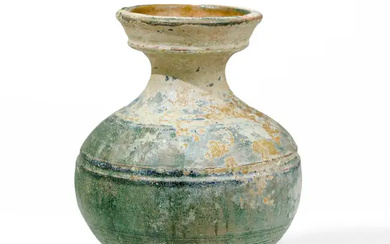 A Chinese green glazed jar, hu Han dynasty With flared mouth above...